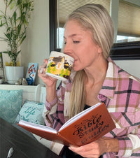 Woman reading the study guide with a cup of coffee