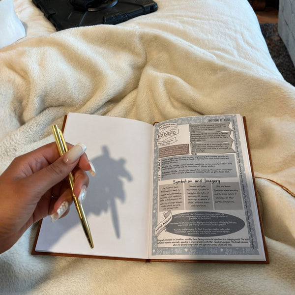Open study guide and pen on a blanket